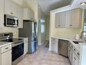 Modern kitchen featuring stainless steel appliances and light cabinets at 10448 Canary Ave, Weeki Wachee, FL 34613
