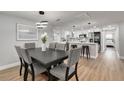 Bright dining room with a dark wood table and gray chairs at 3452 Umber Rd, Holiday, FL 34691