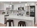 Modern kitchen with white cabinets, quartz countertops, and island at 3452 Umber Rd, Holiday, FL 34691