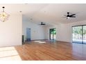 Open concept living room with hardwood floors and pool view at 9053 Nakoma Way, Weeki Wachee, FL 34613