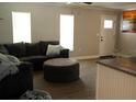 Bright living room featuring a sectional sofa, ottoman, and wood-look flooring at 11261 Redgate St, Spring Hill, FL 34609
