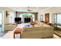 Spacious living room featuring a large sectional sofa and a high ceiling at 12289 Glen Haven St, Spring Hill, FL 34609