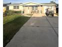 Charming home with a well-maintained front yard and a convenient driveway, perfect for parking a golf cart at 13639 Frances Ave, Hudson, FL 34667