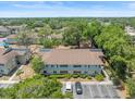 Aerial view of community showing ample parking, mature trees and landscaping, with playground at 230 Thorn Tree Pl # 230, Brandon, FL 33510