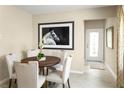 Casual dining area with round wooden table and four chairs, near entryway at 2466 White Ladyfish Rd, Wimauma, FL 33598