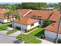 Aerial view of a community of villas with brown roofs and lush green landscaping at 3416 Lori Ln # 4, New Port Richey, FL 34655