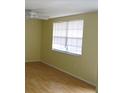 Simple bedroom with light walls and wood flooring at 3605 Richboro Dr, Holiday, FL 34691