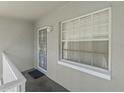 Private condo entry with security door and window at 12141 Spartan Way # 204, Hudson, FL 34667