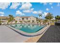 Community pool with lounge chairs at 12141 Spartan Way # 204, Hudson, FL 34667