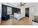 Spacious bedroom with a stylish barn door and a comfortable sitting area at 13022 Payton St, Odessa, FL 33556