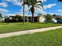 Ranch-style home with landscaped yard at 1354 Linstock Dr, Holiday, FL 34690