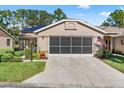 House exterior with garage and American flag at 1400 Summerwood Ct, Spring Hill, FL 34606