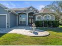 House entrance with stone accents, double doors, and a fountain at 10307 Ridge Top Loop, Weeki Wachee, FL 34613