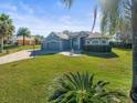 House with gray siding, stone accents, and a landscaped lawn at 10307 Ridge Top Loop, Weeki Wachee, FL 34613