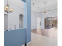 Open living area with tiled floors, and access to pool area at 10307 Ridge Top Loop, Weeki Wachee, FL 34613