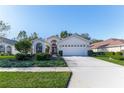 Attractive single-story home with a two-car garage and lush landscaping at 11544 Mcleod St, Spring Hill, FL 34609