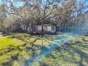 Mobile home with a fenced yard, situated on a spacious lot with mature trees at 12924 Manatee Ave, New Port Richey, FL 34654