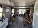 Spacious living room with gray flooring and large windows at 12924 Manatee Ave, New Port Richey, FL 34654
