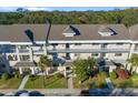 An aerial shot showcasing a condo building with lush landscaping and parking at 2210 Utopian E Dr # 212, Clearwater, FL 33763