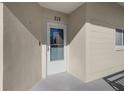 White front door of condo unit with glass panel at 2210 Utopian E Dr # 212, Clearwater, FL 33763