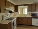 Galley style kitchen with wood cabinets and appliances at 3249 Trask Dr, Holiday, FL 34691