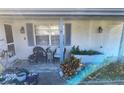 Inviting front porch with seating and potted plants at 7552 Cumber Dr, New Port Richey, FL 34653