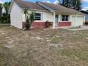 Ranch home with a brick facade and a large yard at 8525 Gandy Ln, Port Richey, FL 34668