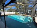Inviting screened-in pool with cool blue water and relaxation-ready hammocks at 1000 Godfrey Ave, Spring Hill, FL 34609