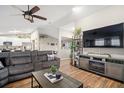 Spacious living room featuring a sectional sofa, large TV, and fireplace at 10464 Henderson St, Spring Hill, FL 34608