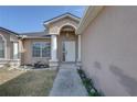 Front entrance with white columns and door at 11463 Cavern Rd, Spring Hill, FL 34609