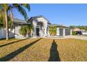 Two-story house with a three-car garage and palm trees at 11528 Andy Dr, Riverview, FL 33569