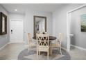 Small dining area with round table and four chairs, near entryway at 14112 Crimson Ave, Lakewood Ranch, FL 34211