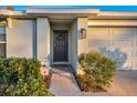 Dark gray front door adorned with a lemon wreath at 5324 Dellbrook Ave, Spring Hill, FL 34608