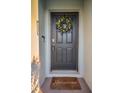 Dark gray front door with a lemon and greenery wreath at 5324 Dellbrook Ave, Spring Hill, FL 34608