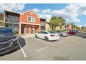 Condo building with parking spaces and palm trees at 5576 Baywater Dr # 5576, Tampa, FL 33615