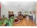 Spacious living room with hardwood floors and fireplace at 6527 Mulligan Ct, Spring Hill, FL 34606