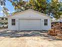 Detached single-car garage with a large driveway at 7195 Bethesda Ct, Weeki Wachee, FL 34607