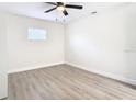 Spacious bedroom with light wood flooring and large window at 7400 Mitchell Ranch Rd, New Port Richey, FL 34655