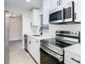 Modern kitchen featuring stainless steel appliances and white cabinets at 7400 Mitchell Ranch Rd, New Port Richey, FL 34655