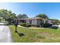 Side view of the condo showing landscaping and driveway at 8131 Braddock Cir # 4, Port Richey, FL 34668