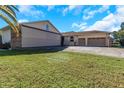Large garage with a plane hangar door and additional garage space at 8700 Cessna Dr, New Port Richey, FL 34654