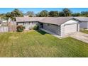 Grey home with a spacious yard and driveway at 9139 Fairweather Dr, Largo, FL 33773