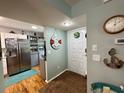 Bright entryway with view of kitchen and nautical decor at 12042 Hoosier Ct # 104, Hudson, FL 34667