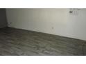Simple bedroom with wood-look floors and a window at 12719 Lockey Ln, Tampa, FL 33612