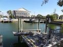 Wooden boat lift and dock overlooking a calm waterway at 13730 Gene Rossi Ave, Hudson, FL 34667