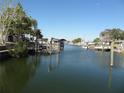 Calm waterway with docked boats and waterfront homes at 13730 Gene Rossi Ave, Hudson, FL 34667