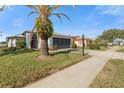 House exterior showcasing a palm tree and a driveway at 18109 Webster Grove Dr, Hudson, FL 34667