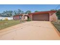 View of the home's exterior, including the driveway and garage at 186 Dan River Dr, Spring Hill, FL 34606