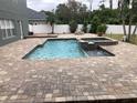 Inviting pool and spa with a large brick patio at 1922 Oswego Dr, Holiday, FL 34691