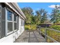 Wooden deck with a bistro set overlooking the backyard at 24141 Mondon Hill Rd, Brooksville, FL 34601